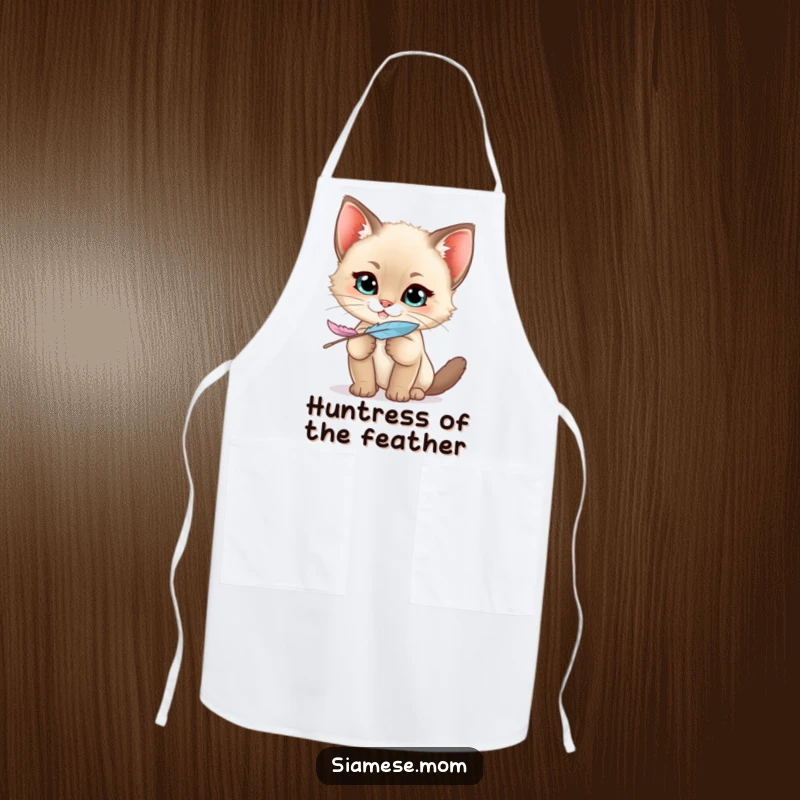Funny Siamese Kitten Apron showing a kawaii cat with a mischievous grin holding a feather, ready for playful kitchen duties.