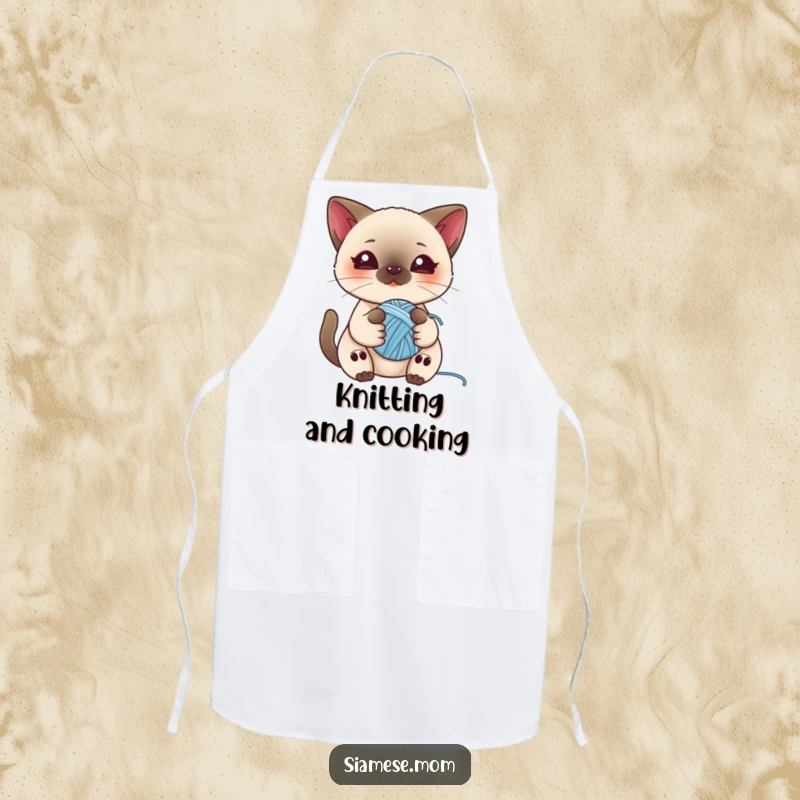 Funny apron with a kawaii Siamese cat playing with a ball of yarn, ideal for kitchen tasks and adding feline charm.