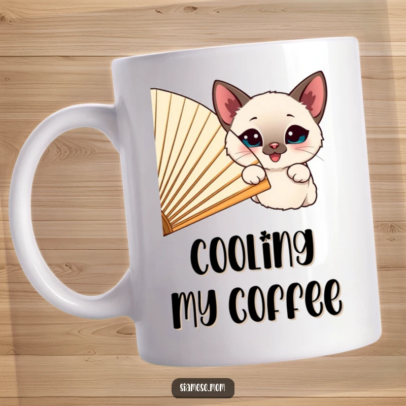 Funny happy Siamese cat peeking curiously from behind a large, cheerful fan, perfect for a funny gift mug.