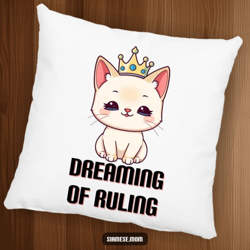 Funny decorative pillow featuring a kawaii Siamese cat wearing a tiny crown, looking pleased and regal.
