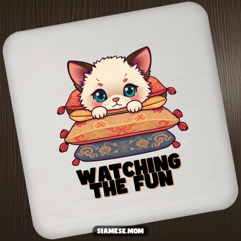 Funny Siamese cub peeking from behind cushions, a cute kitten on a durable drink coaster for stylish, funny table protection.