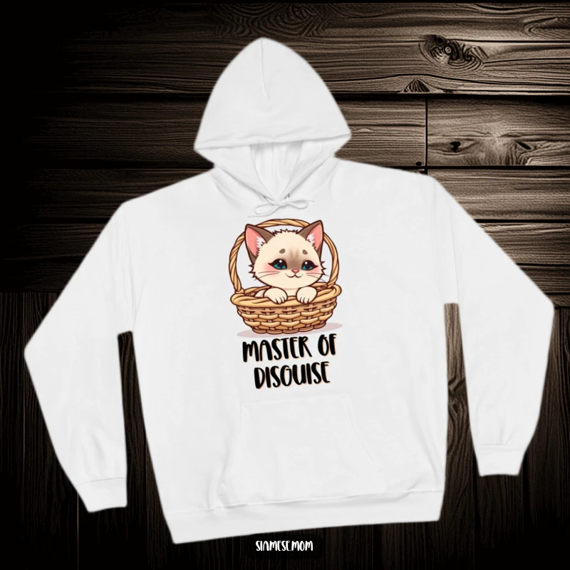 Funny Siamese Cat Hoodie, cute kawaii cat peeking from a basket with a smirk, ideal funny gift for cat enthusiasts.