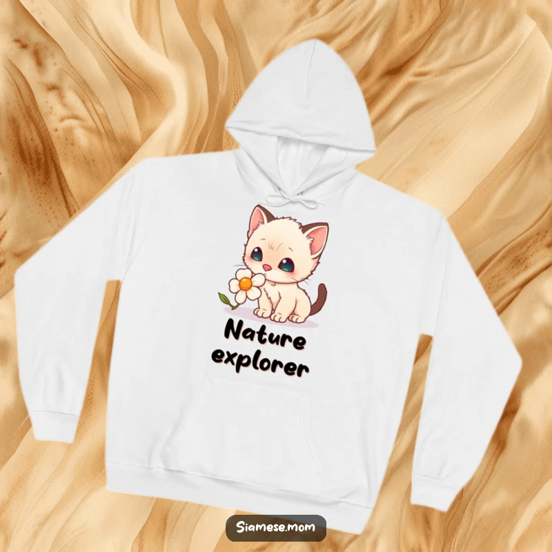 Funny Hoodie: A heartwarming scene of a kawaii Siamese kitten with delicate whiskers sniffing a bright daisy.