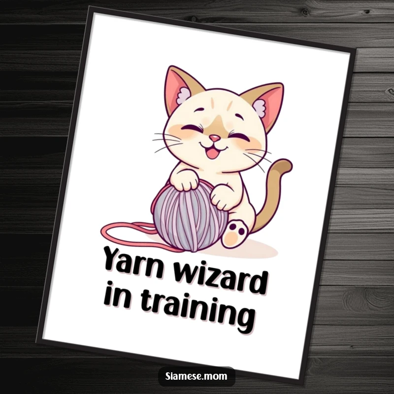 Funny Free Printable Wall Art: A stylized Siamese cat with a happy smile, playfully interacting with a rolling ball of yarn.