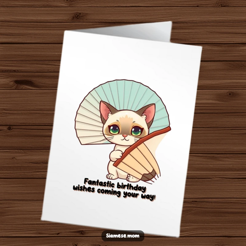 Funny Free Printable Birthday Card: Siamese cat peeking from behind a fan, ready to surprise you with birthday wishes.