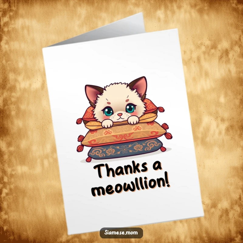 Free Printable Thank You card showcasing a fluffy Siamese cub peeking from behind cushions, expressing thanks.