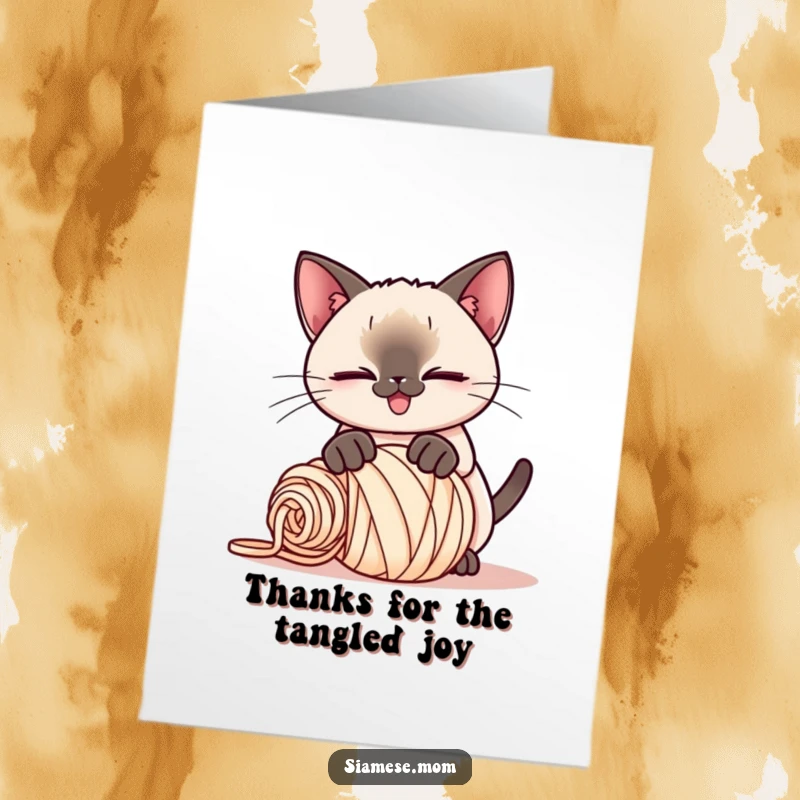 Funny Free Printable Thank You Card: Kawaii Siamese cat with a playful smirk pounces on a ball of yarn, hinting at playful thanks.