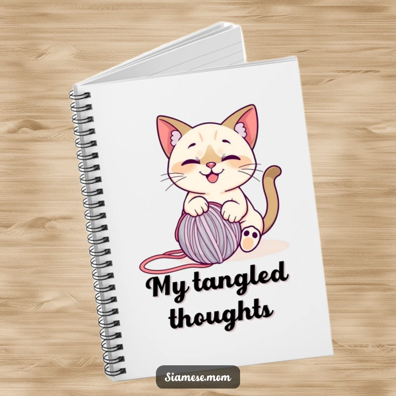 Funny Siamese Cat Notebook: Features a smiling cat playfully engaged with a rolling ball of yarn, perfect for note-taking.