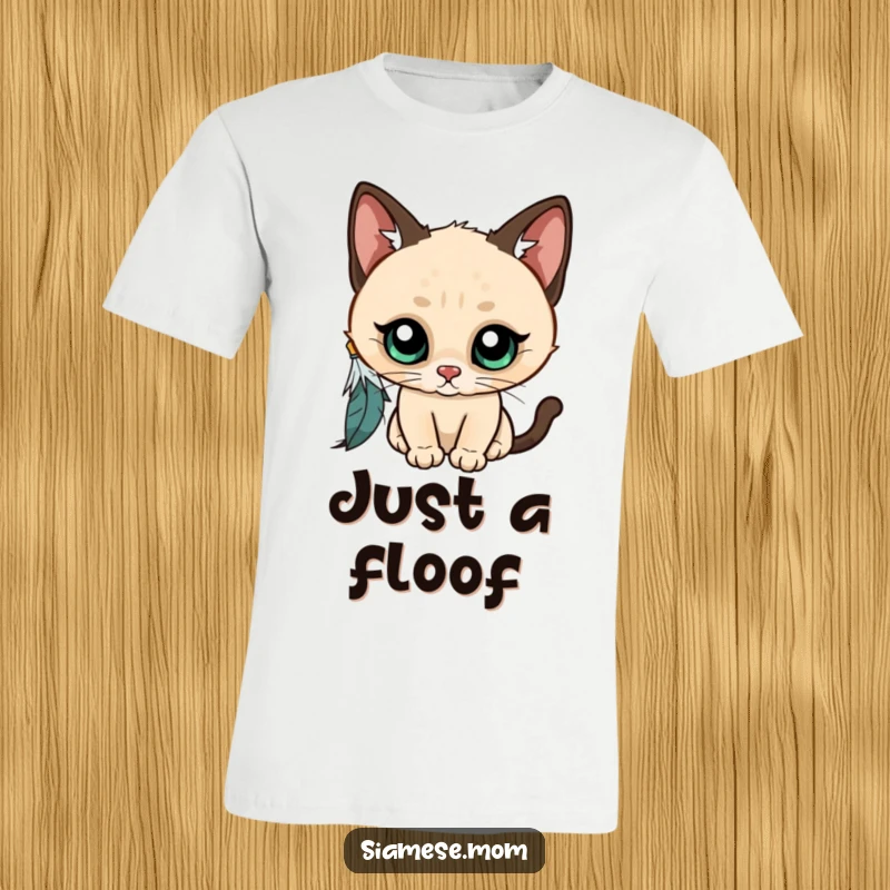 Funny Kawaii Siamese cat t-shirt, wide-eyed and curious, playfully batting at a dangling feather, a hilarious depiction of feline fascination.