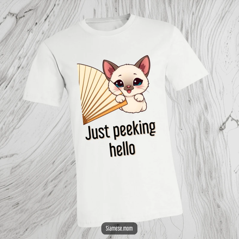 Funny happy Siamese cat peeking from behind a large, cheerful fan, printed on a soft t-shirt.