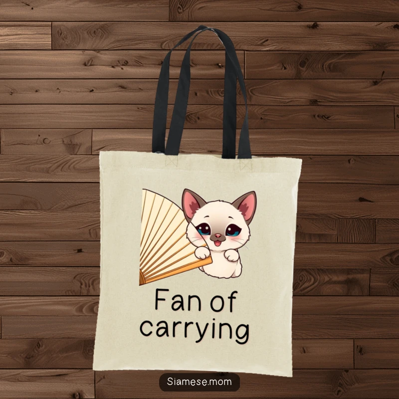 Funny happy Siamese cat peeking from behind a large, cheerful fan, printed on a durable tote bag.