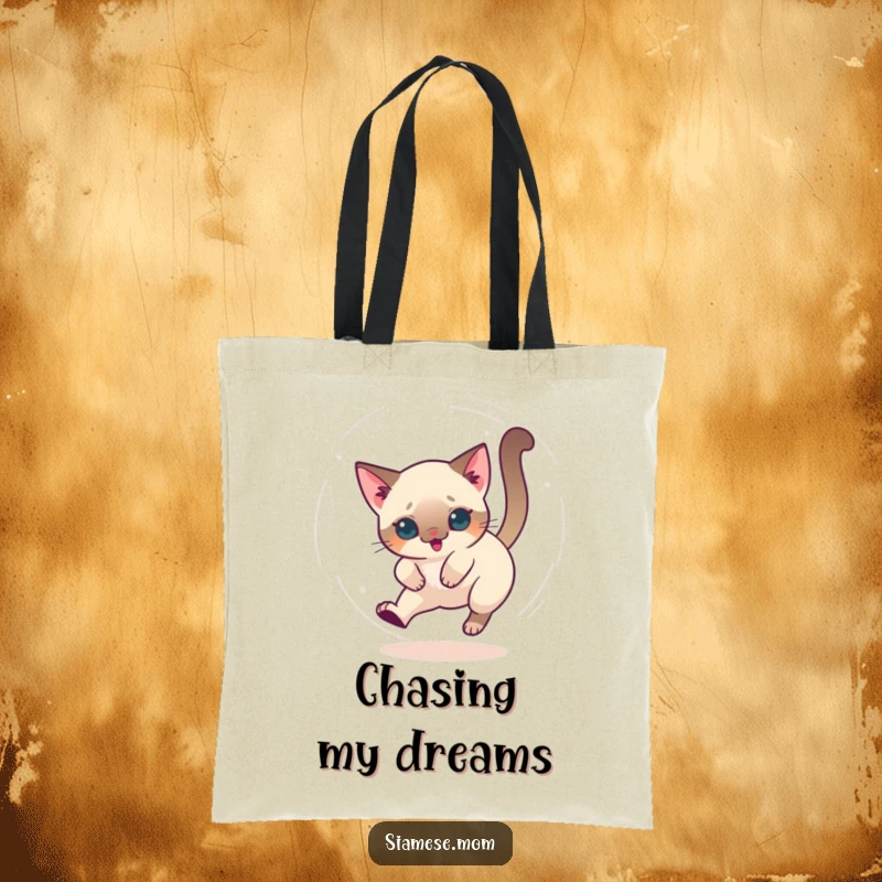 Funny tote bag featuring a kawaii Siamese cat chasing its tail in a dizzy circle, perfect for carrying fun.