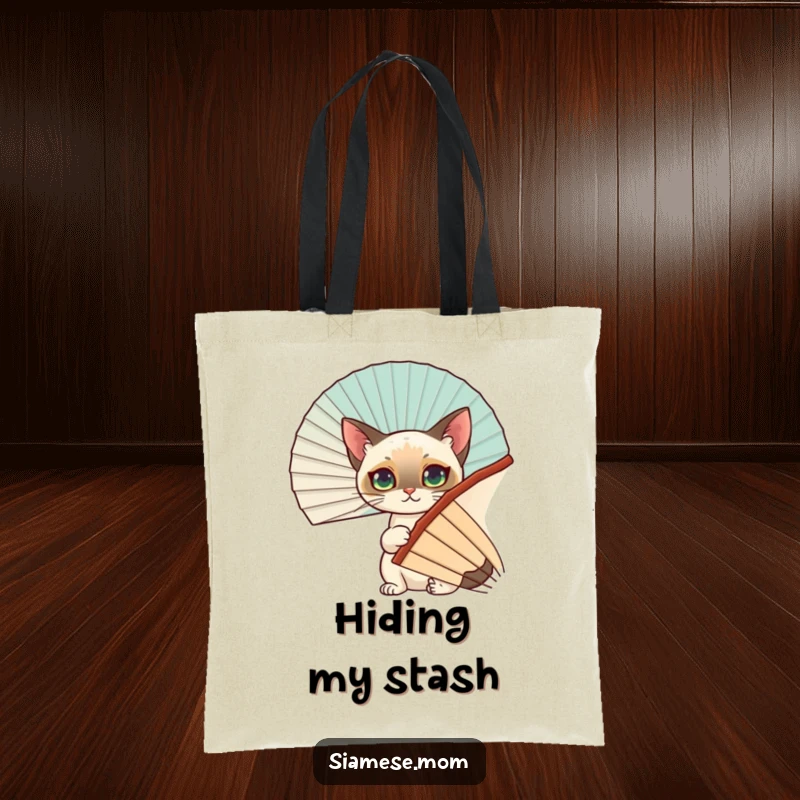 Funny Siamese Cat Tote Bag: A witty Siamese cat uses a decorative fan as a hiding spot, perfect for carrying essentials with personality.