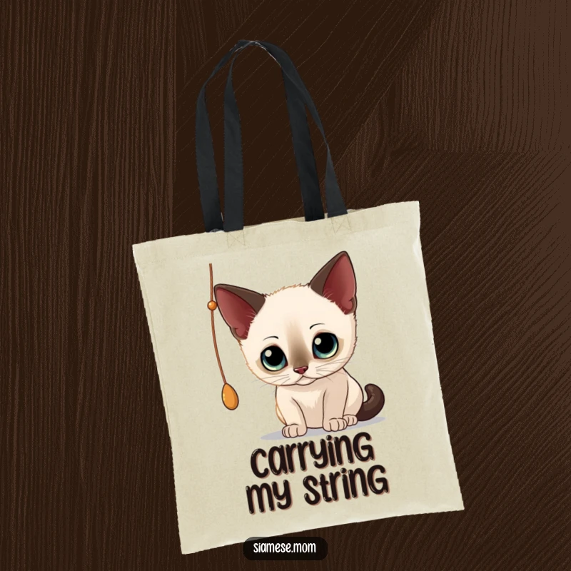 Funny Siamese Cat Tote Bag: Charming illustration of a curious cat batting at a dangling string, perfect for everyday use.